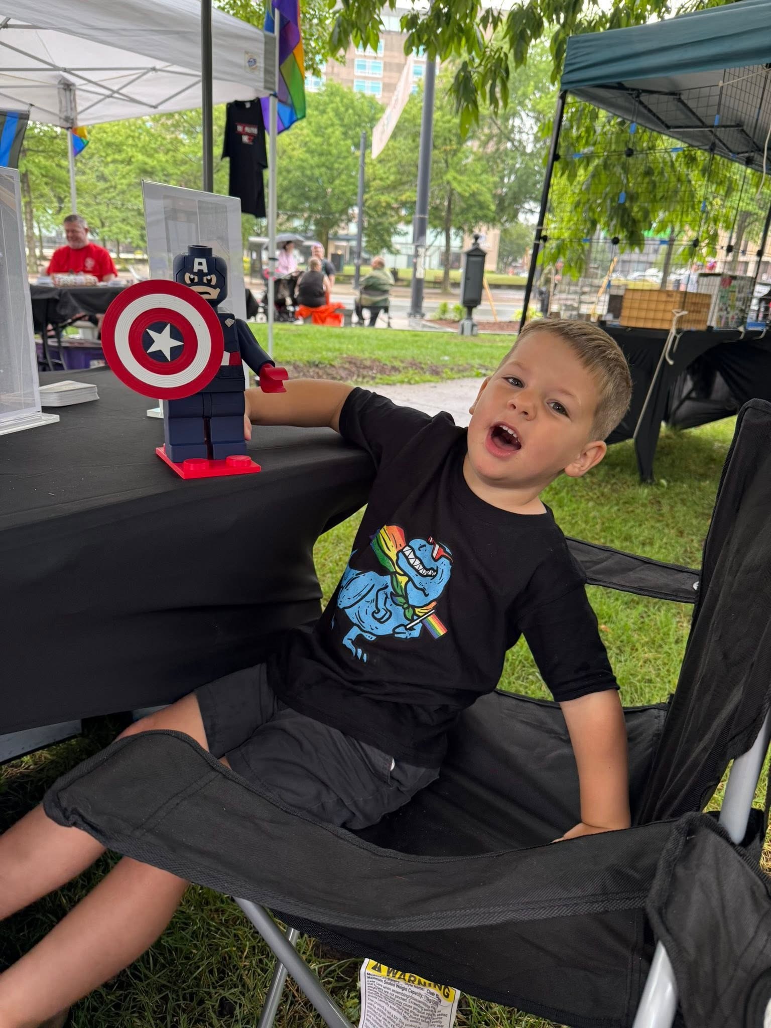 KPI family member with a Captain America figure at a community event