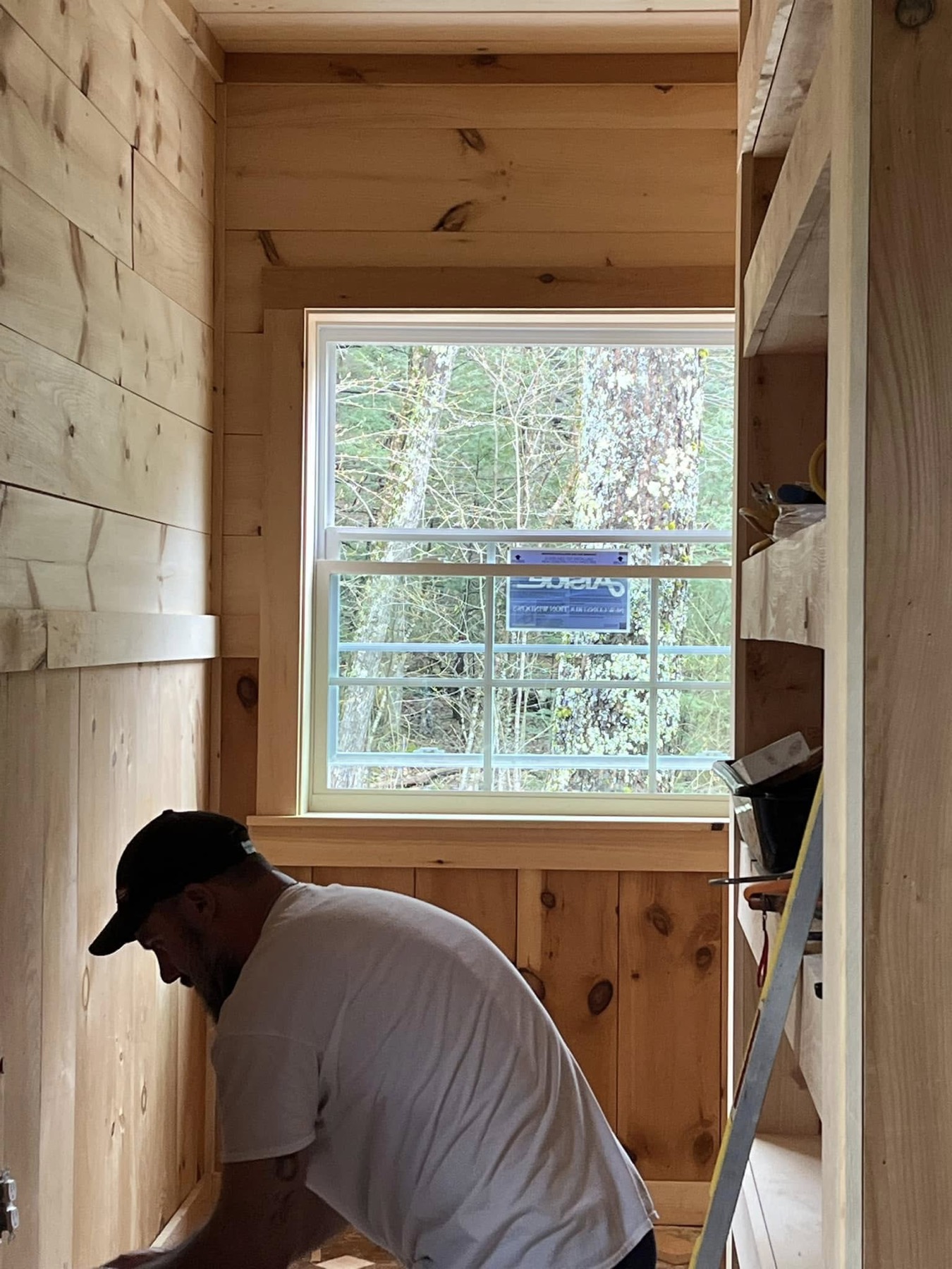 Carpenter working inside a wood-paneled room