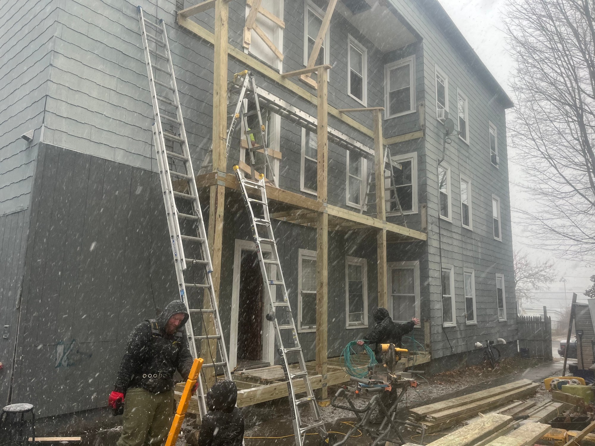 KPI crew completing exterior property work during snowfall