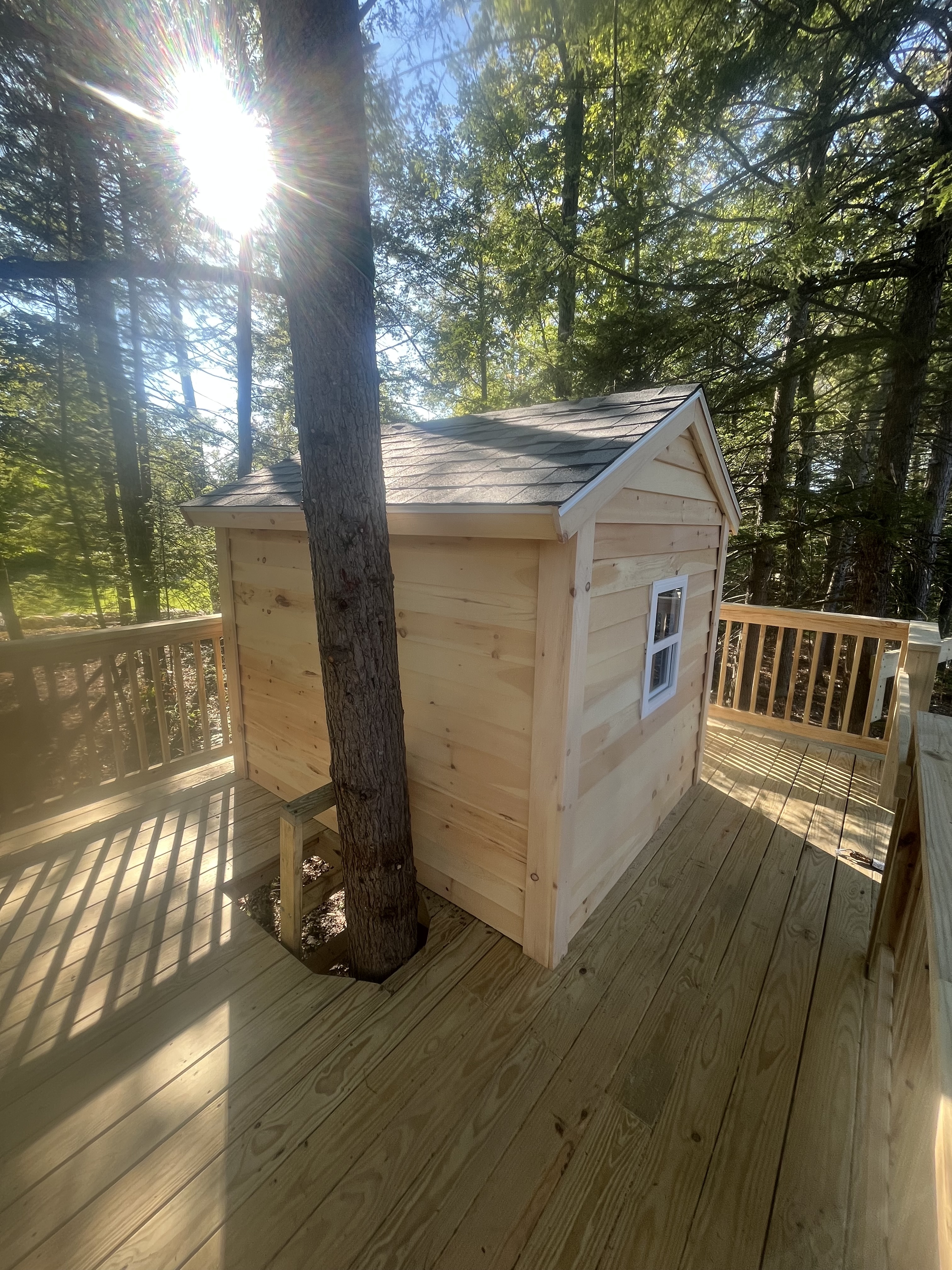 Custom treehouse built into a wooded deck